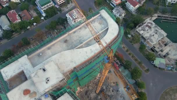 Aerial shot of the construction site with one onstruction crane. Tall building construction concept — Stock Video