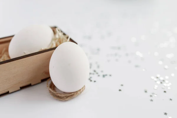 Easter. Easter eggs in a wooden box. Silver. Bokeh.