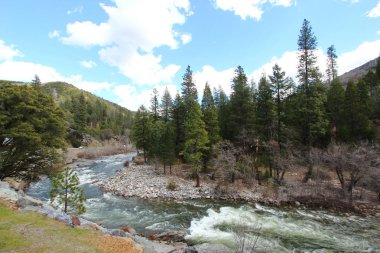 A river with rapids in the mountains in California enroute Lake Tahoe. clipart