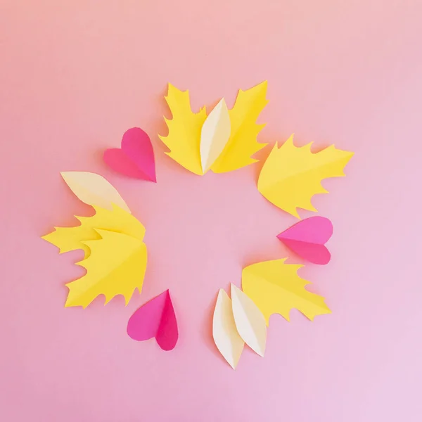 yellow leaves and hearts in circle on pink background