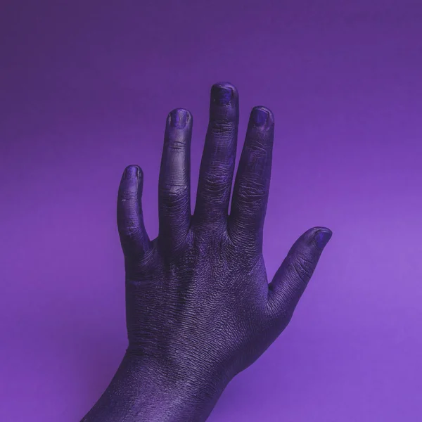 Female hand, stop gesture, direction symbol, fashion background, show, presentation, purple neon colors. Minimalism