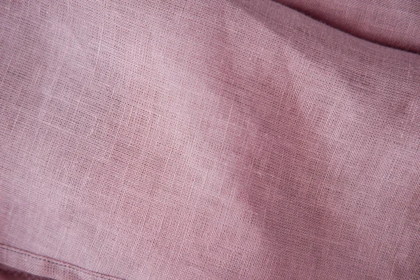 Blush pink soft linen fabric texture. Delicate sensual folds.