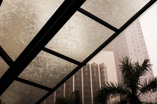 Aluminum metal frame glass curtain wall. Window roof construction details. Exterior design. Rain drops