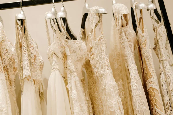 Cream wedding dresses hanging on the rack — Stock Photo, Image
