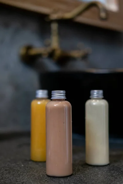 Kosmetik spa dalam botol di atas meja abu-abu gelap — Stok Foto