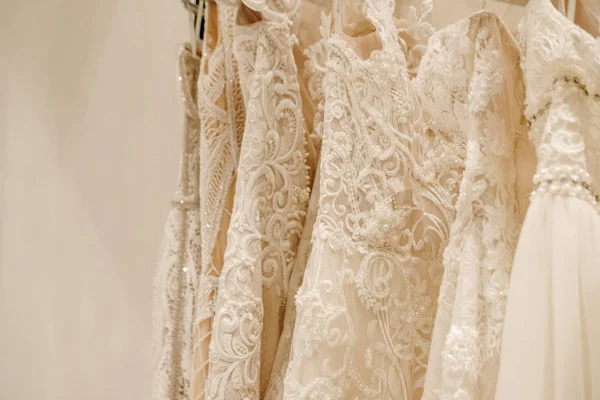 Cream wedding dresses hanging on the rack — Stock Photo, Image