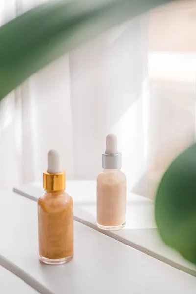 Glass bottles with skincare essential serum on white — Stock Photo, Image