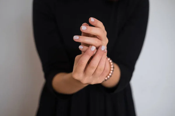 Woman's hands with white nail polish — Stock Photo, Image