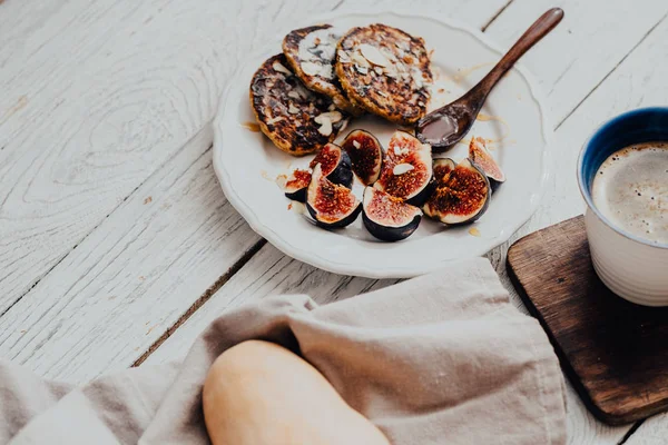 Pumpkin pancakes with figs on white wooden table — Stock Photo, Image