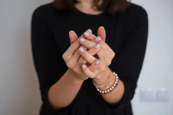 Woman's hands with white nail polish — Stock Photo, Image