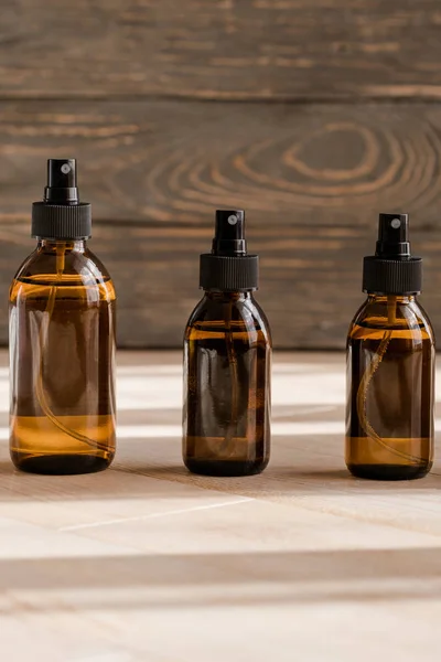 Cosmetic dark amber bottles on wooden  table Royalty Free Stock Photos