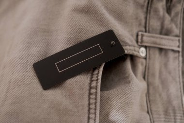 Gri kot kumaşında siyah etiket. Moda markası maketi