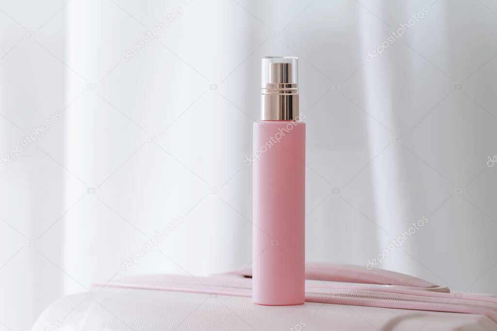 Pink cosmetic bottle on white background. Commercial beauty product photography. Brand package mockup. 