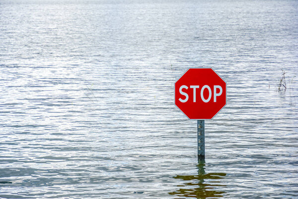 Flooding and road sign of priority Traveling without stopping is prohibited in water with watermarks. Traffic Laws, highway code.