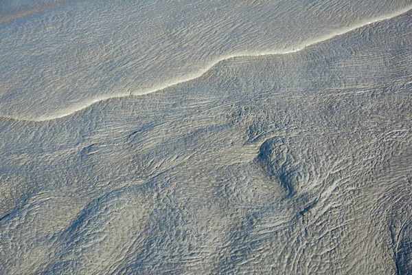 Schlammfluss aus einem Schlammvulkan. Rissige Schlammoberfläche. Mudflow Textur mit Rissen. — Stockfoto