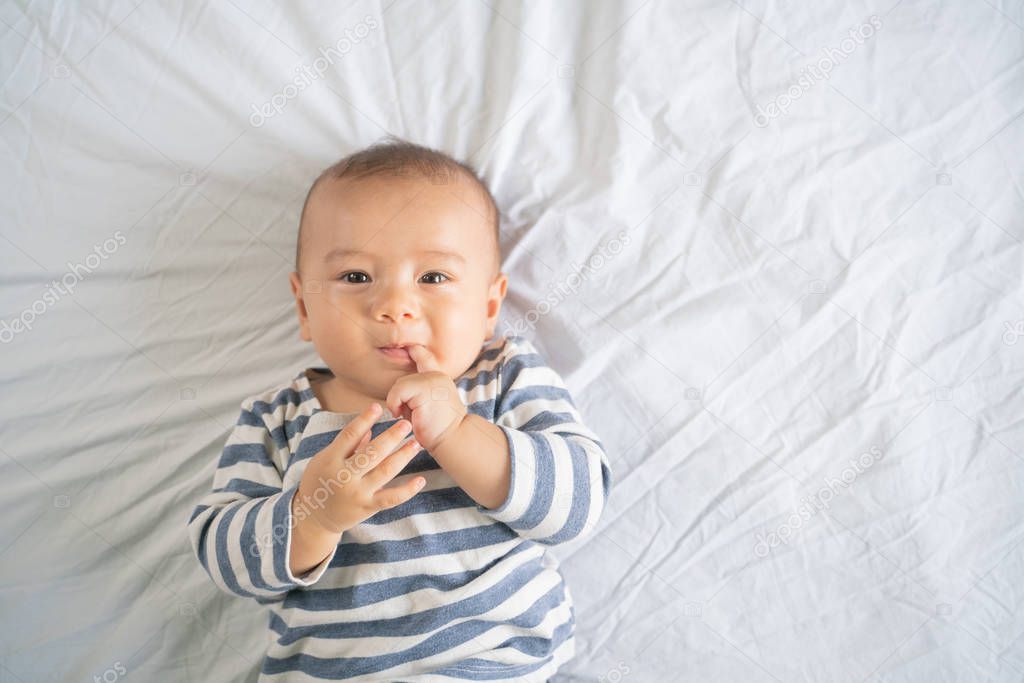 The little boy in the bedroom in bed.