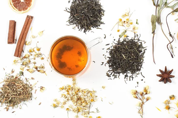 tea and herbs lie on a white background