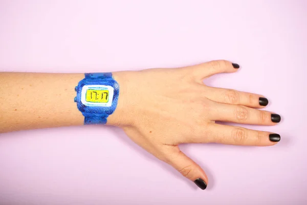 a clock painted on a woman's hand has a place for an inscription