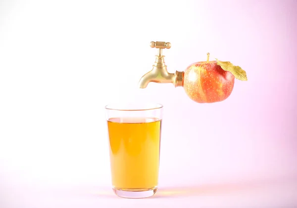 apple red with a small tap and a glass with juice