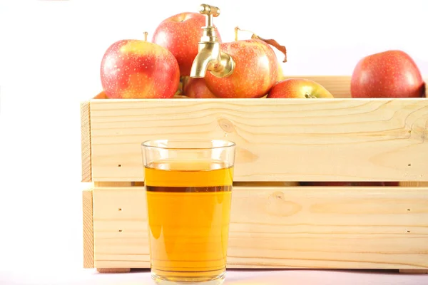 the tap in the Apple and a glass of Apple juice is on the table