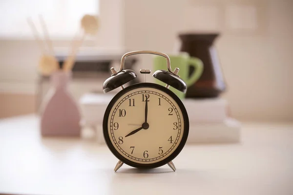 clock alarm clock stands at home on the table in the morning