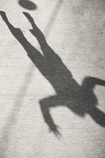 the shadow of a man on the pavement background image