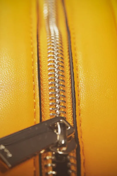 zipper on yellow leather bag