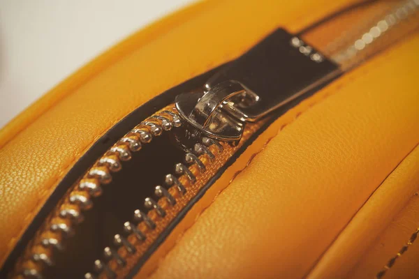 zipper on yellow leather bag