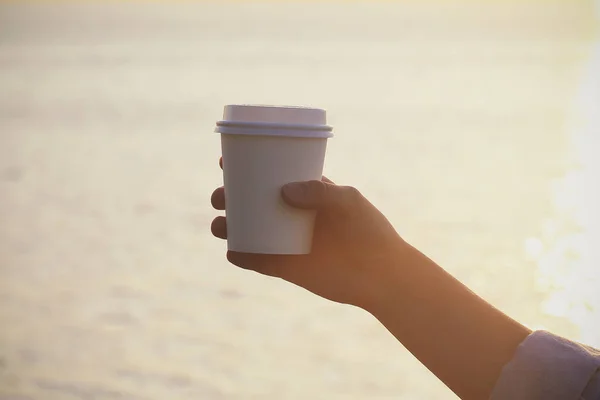 white paper Cup with coffee in nature