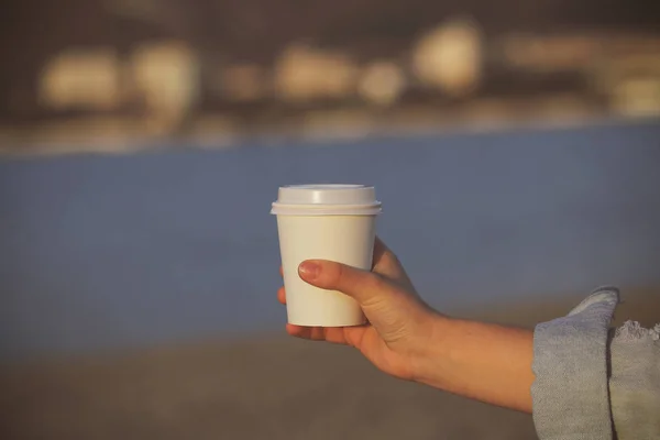 white paper Cup with coffee in nature