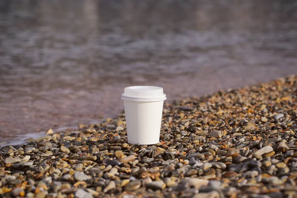 white paper Cup with coffee in nature