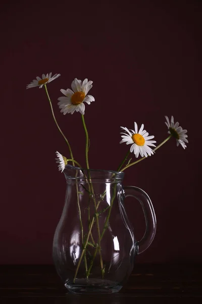 a bouquet of flowers standing in the vase on the night