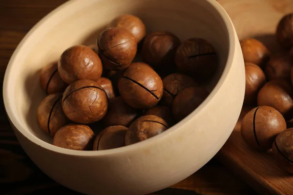 macadamia nuts lie on a black background