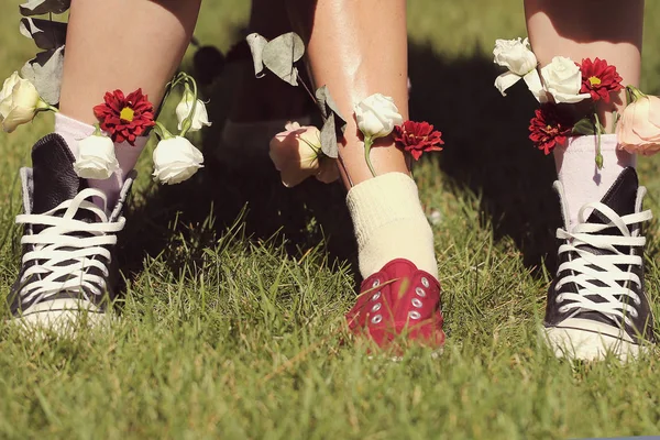 women\'s feet in socks they are inserted flowers