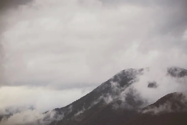 rain clouds and clouds over the city and mountains