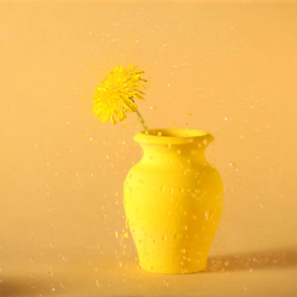 a yellow wooden vase stands on a yellow background