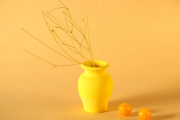 a yellow wooden vase stands on a yellow background