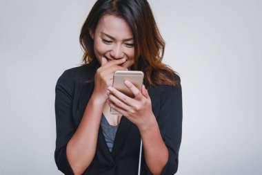 Asyalı kadınlar cep telefonlarını kullanıyor. Mutlu ruh hali