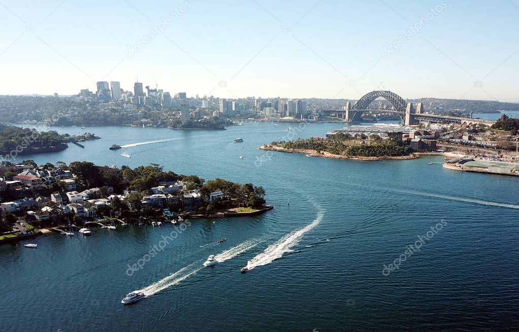 Aerial view of Sydney Harbour, Harbour Bridge with North Sydney financial district skyscrapers.