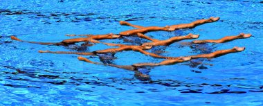 Grand jete. Synchronized swimmers legs movement. Synchronized swimming team performing a synchronized routine of elaborate moves in the water. clipart