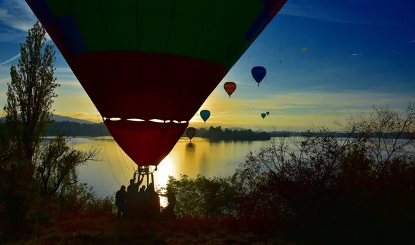 Hot air balloon landing at Lake Burley Griffin, as part of the Balloon Spectacular Festival in Canberra.
