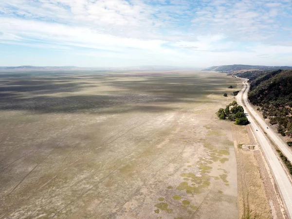 Empty Lake George nestled between a rural wind farm and farmland in Australia. Lake George is an endorheic lake, as it has no outflow of water to rivers and oceans.