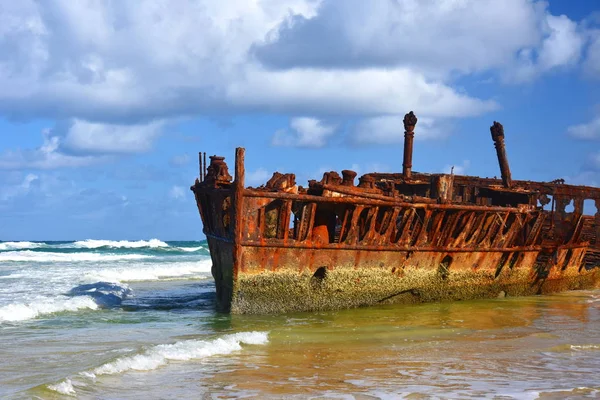rusty wreck of vessel Maheno on shores of Fraser Island (Queensland, Australia). antique rusty and damaged boat and corrosion in ocean
