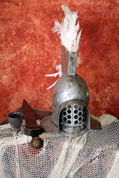 Steel roman gladiator helmet, with a short sword of \