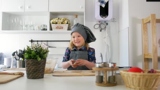 Petite fille boulanger roule la pâte et parler — Video