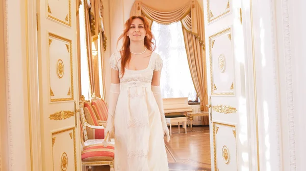 Hermosa mujer en un vestido de baile entra en el salón de baile — Foto de Stock