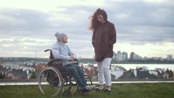 Boldog fogyatékkal élő ember egy tolószékben nő beszél a hegyen — Stock videók