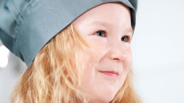 Portrait of little girl dressed as a chef waving a whisk — Stock Video