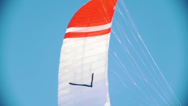 Flying colorful sail for kite boarding in the sky — Stock Video