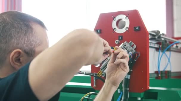 Elettricista lavora con pannello di energia e macchinari attrezzature in impianto — Video Stock